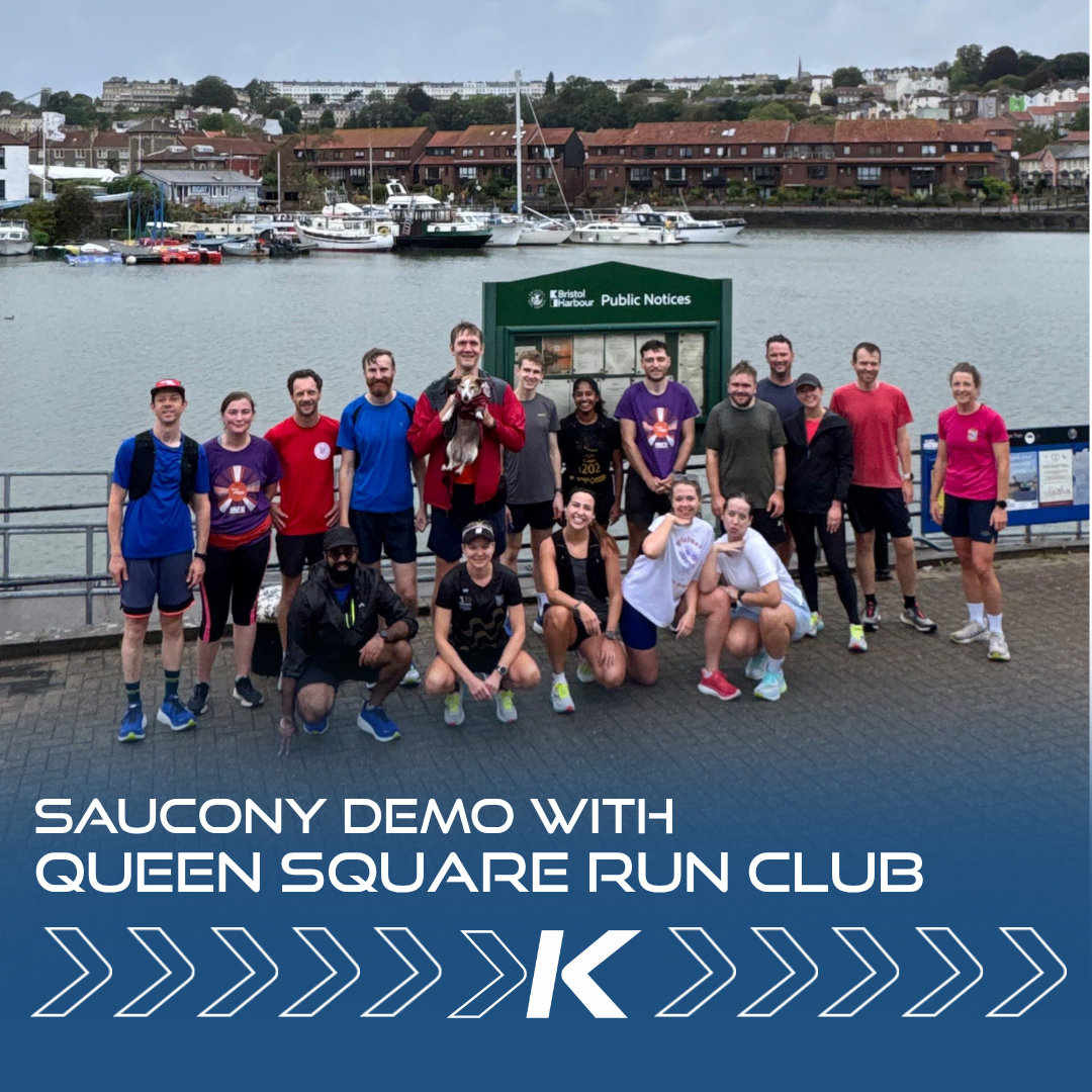 Runners from Queen Square Run Club posing for a picture in front of the Bristol harbour