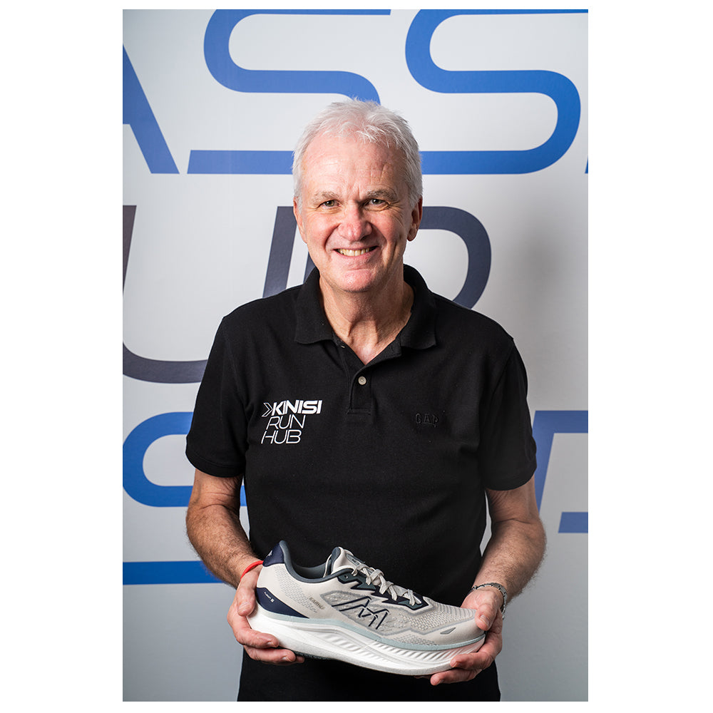 Photograph of Graham at Kinisi Run Hub holding a running shoe.