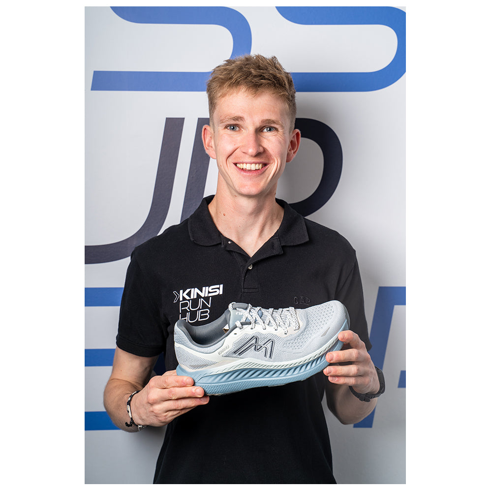 Photograph of Jamie at Kinisi Run Hub holding a running shoe.