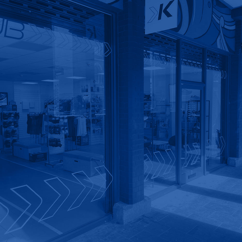 Photo of the exterior of the Kinisi Run Hub store, with a blue overlay