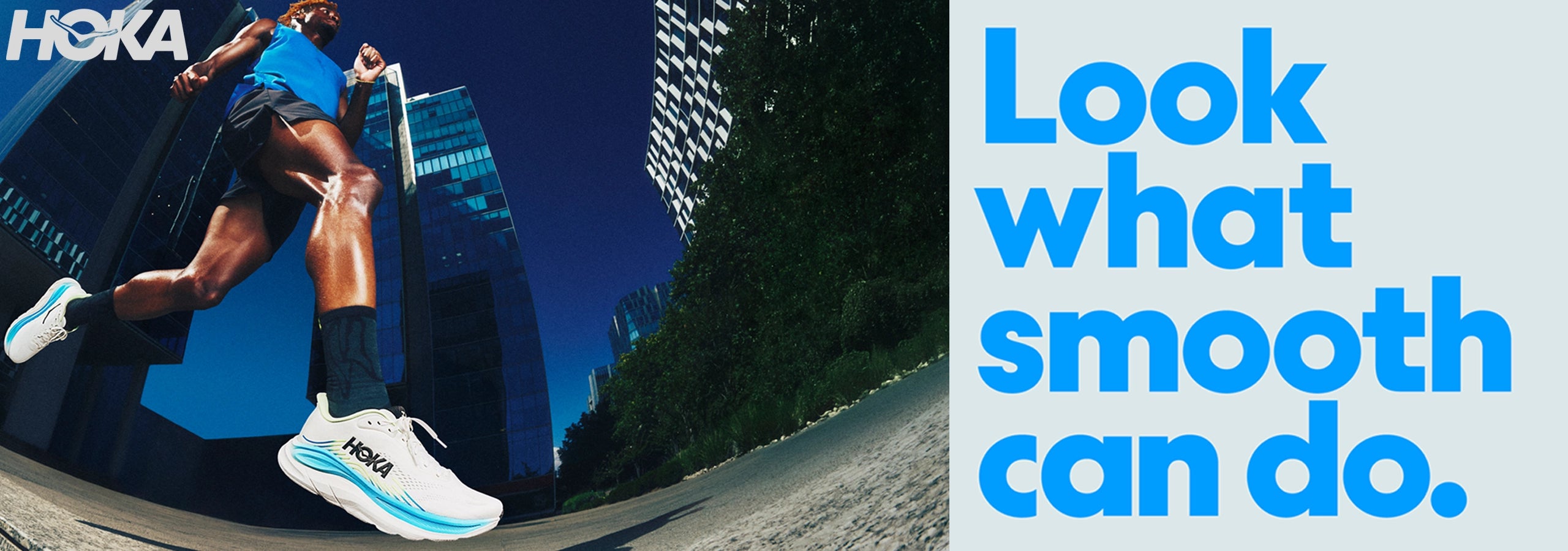A Hoka runner in a blue top and black shorts runs through a city street with skyscrapers in the background, alongside large blue text on a light gray panel that reads, 'Look what smooth can do.'.