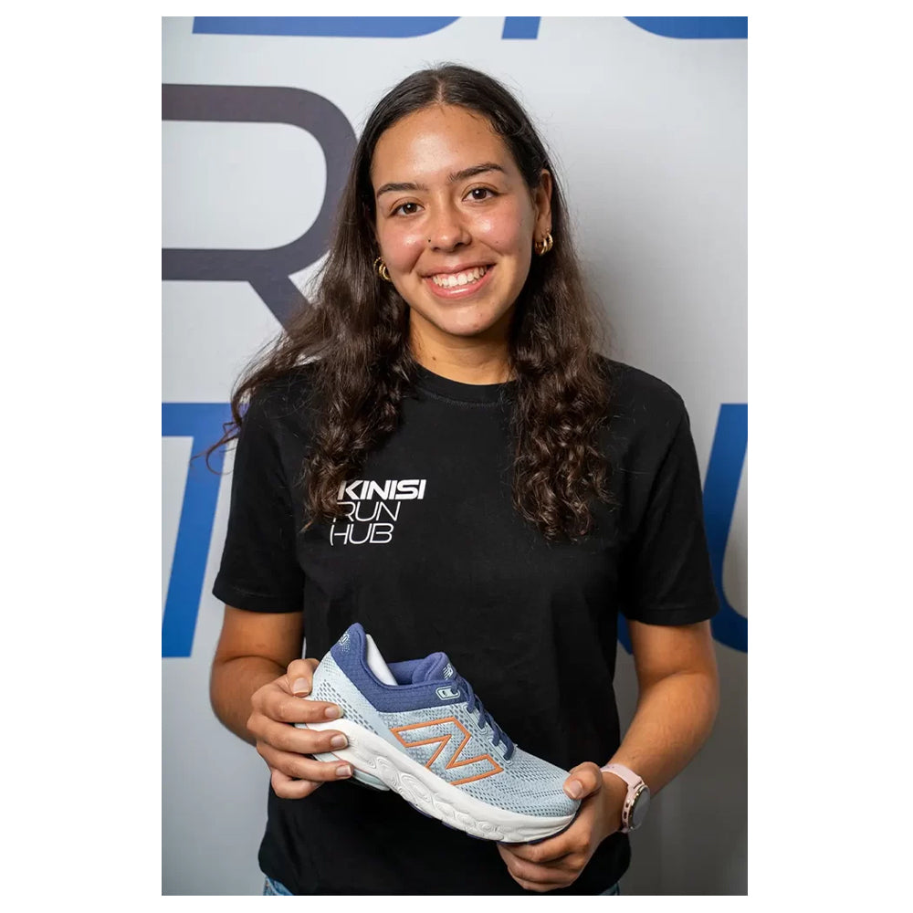 Image of Megan from Kinisi Run Hub holding a running shoe