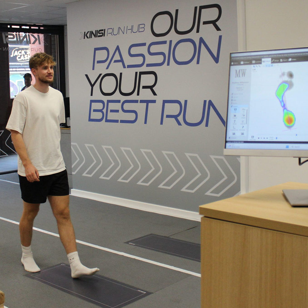 Photograph of a customer at Kinisi Run Hub walking along the running track for movement analysis