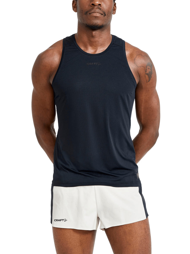 Photograph a man wearing a black running top and white running shorts against a white background