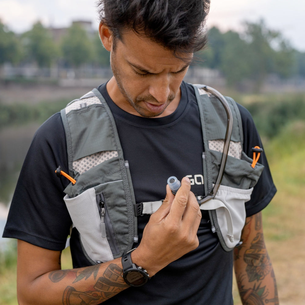 Photograph of a man outside wearing a running hydration vest