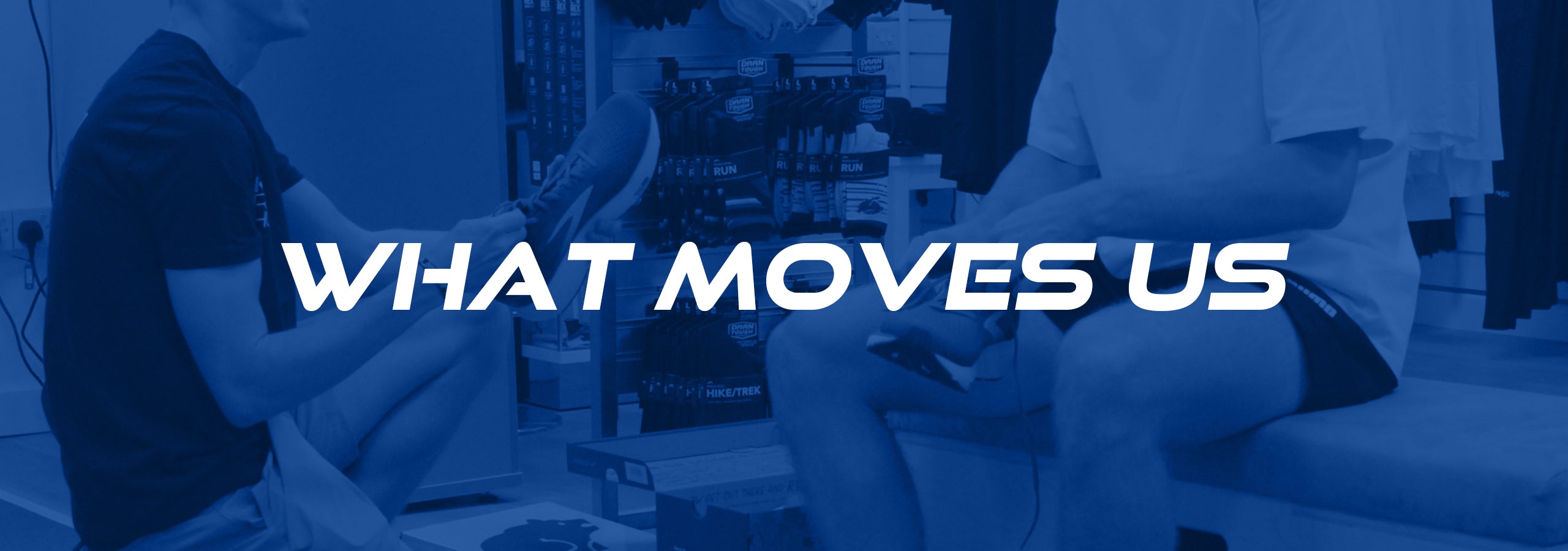 Image a shoe fitting taking place at Kinisi Run Hub with a blue overlay and text reading 'what moves us' in white