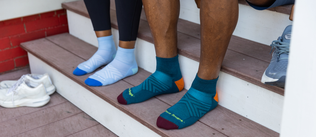 Socks are designed to have a snug fit. The more yarn that is knitted into each square inch of the sock ensures a better fit and more durability.